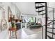 Bright living room features spiral staircase, fireplace, console table, large windows and a comfortable looking couch at 5103 Puritan Cir # 5103, Tampa, FL 33617