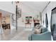 Bright living room with spiral staircase, stylish furniture, fireplace, and view to dining area at 5103 Puritan Cir # 5103, Tampa, FL 33617