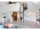 Bright living room with a spiral staircase, tiled floors, and an open layout at 5103 Puritan Cir # 5103, Tampa, FL 33617