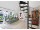 Living room featuring a spiral staircase, stylish furnishings, and view to outdoor balcony at 5103 Puritan Cir # 5103, Tampa, FL 33617