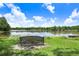 Picturesque lake view with a bench overlooking the calm water and lush greenery at 5103 Puritan Cir # 5103, Tampa, FL 33617