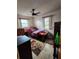 Bedroom with light tile flooring, ceiling fan, and bright windows, offering a relaxing atmosphere at 5221 82Nd N Ave, Pinellas Park, FL 33781