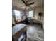 Bedroom featuring a ceiling fan, wood-look vinyl flooring, and natural light from the windows at 5221 82Nd N Ave, Pinellas Park, FL 33781