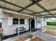 Covered carport providing shade and protection, includes seating area and secure surveillance at 5221 82Nd N Ave, Pinellas Park, FL 33781