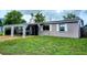 Charming single-story home with covered parking, well-maintained lawn, and neutral-toned exterior at 5221 82Nd N Ave, Pinellas Park, FL 33781