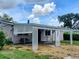 Home exterior featuring an extended carport with decorative lattice, providing sheltered access and curb appeal at 5221 82Nd N Ave, Pinellas Park, FL 33781