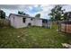 Exterior view of the home featuring a grassy backyard and an AC unit at 5221 82Nd N Ave, Pinellas Park, FL 33781