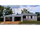 Charming home with solar panels, light brown gravel, and a white lattice porch at 5221 82Nd N Ave, Pinellas Park, FL 33781