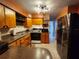 Efficient kitchen with wooden cabinetry, and stainless steel refrigerator at 5221 82Nd N Ave, Pinellas Park, FL 33781