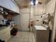 Laundry room with tile flooring, overhead cabinets, and a washer, providing practical amenities at 5221 82Nd N Ave, Pinellas Park, FL 33781