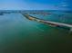 Bright aerial view of bay waters, cityscape, and the bridge crossing the bay at 55 Rogers St # 502, Clearwater, FL 33756