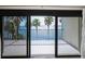 Balcony with sliding glass doors offering views of palm trees and the bay at 55 Rogers St # 502, Clearwater, FL 33756