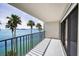 Enjoy the view of the water from this tiled balcony with black metal railings and sliding glass doors at 55 Rogers St # 502, Clearwater, FL 33756