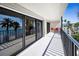 Spacious balcony with tile flooring, seating area, and beautiful views of the water and palm trees at 55 Rogers St # 502, Clearwater, FL 33756