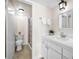 Bathroom features white cabinets, modern lighting, and a shower/tub combo at 55 Rogers St # 502, Clearwater, FL 33756