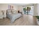 Bright bedroom with a large window overlooking a beautiful waterfront view and hardwood floors at 55 Rogers St # 502, Clearwater, FL 33756