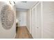 Hallway featuring wood-look flooring, decorative wall art, and closet with louvered doors at 55 Rogers St # 502, Clearwater, FL 33756