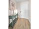 Entry hallway features light wood-look flooring and a decorative console table with art at 55 Rogers St # 502, Clearwater, FL 33756