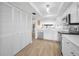 Open kitchen layout with white cabinetry, stainless appliances, and seamless flow to living areas at 55 Rogers St # 502, Clearwater, FL 33756