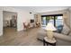Living room with water view through sliding doors, comfortable seating, and an open layout at 55 Rogers St # 502, Clearwater, FL 33756