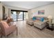 Bright living room with waterfront views, neutral furnishings, and sliding glass doors to balcony at 55 Rogers St # 502, Clearwater, FL 33756