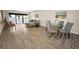 Open living space with hardwood floors, access to the balcony, and neutral-toned furnishings at 55 Rogers St # 502, Clearwater, FL 33756