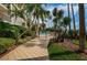 Relaxing pool area with tropical landscaping, inviting gated entrance, and distant ocean views at 55 Rogers St # 502, Clearwater, FL 33756