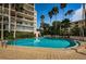 Inviting community swimming pool with clear blue water, lounge chairs, and manicured landscaping at 55 Rogers St # 502, Clearwater, FL 33756