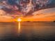 Golden sunset reflecting on the water with boats and buildings silhouetted against the colorful sky at 55 Rogers St # 502, Clearwater, FL 33756