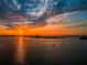 Stunning sunset over water, featuring the horizon with clouds and a reflective glow at 55 Rogers St # 502, Clearwater, FL 33756