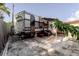 This spacious backyard includes a trailer with awning, a wooden fence, and sparse vegetation at 5601 Golden Dr, Tampa, FL 33634