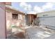 Backyard featuring brick and concrete ground cover, pink external walls, and a white fence at 5601 Golden Dr, Tampa, FL 33634