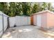 A brick backyard featuring two sheds and plenty of trees for a relaxed, outdoor feel at 5601 Golden Dr, Tampa, FL 33634