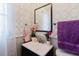 Stylish bathroom vanity with patterned wallpaper, mirror, and fresh decor accents creates a welcoming space at 5601 Golden Dr, Tampa, FL 33634