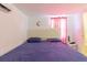 Cozy bedroom with tile floors, a queen bed, and a view to the bathroom at 5601 Golden Dr, Tampa, FL 33634