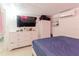 Bedroom featuring tile floors, a queen bed, and a dresser with TV and closet at 5601 Golden Dr, Tampa, FL 33634