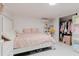 Comfortable bedroom with soft pink bedding, organized closet space, and charming decor provides a relaxing ambiance at 5601 Golden Dr, Tampa, FL 33634