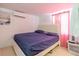 Comfortable bedroom featuring neutral walls, tile floors, and pink curtains at 5601 Golden Dr, Tampa, FL 33634