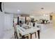 Open dining and kitchen area featuring stainless steel appliances, a breakfast bar, and modern lighting at 5601 Golden Dr, Tampa, FL 33634