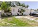Charming single-story home with a unique pink brick facade and lush tropical landscaping at 5601 Golden Dr, Tampa, FL 33634