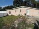 Charming pink brick home with a well-maintained lawn and decorative window accents at 5601 Golden Dr, Tampa, FL 33634
