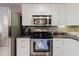 Bright kitchen featuring stainless steel appliances, white cabinets, and tiled backsplash for modern appeal at 5601 Golden Dr, Tampa, FL 33634