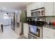 Functional kitchen space with stainless steel appliances, ample cabinet storage, and convenient laundry area at 5601 Golden Dr, Tampa, FL 33634