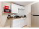 Kitchen featuring tile floors, white cabinets, and stainless steel appliances at 5601 Golden Dr, Tampa, FL 33634