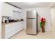 Kitchen featuring tile floors, white cabinets, and stainless steel appliances at 5601 Golden Dr, Tampa, FL 33634