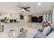 Open-concept layout showcasing the living room connected to the kitchen with bar seating and a gray sofa at 5601 Golden Dr, Tampa, FL 33634