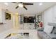 Stylish living room with a mirrored entertainment center, tile floors, and a contemporary ceiling fan at 5601 Golden Dr, Tampa, FL 33634