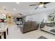 Modern living room with tile floors, mirrored accents, open layout and comfortable gray couch at 5601 Golden Dr, Tampa, FL 33634