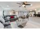 Open concept living area featuring modern decor, tile flooring, and an elegant mirrored coffee table at 5601 Golden Dr, Tampa, FL 33634
