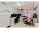 Bright office space featuring dual computer setups, white furnishings, and a ceiling fan at 5601 Golden Dr, Tampa, FL 33634